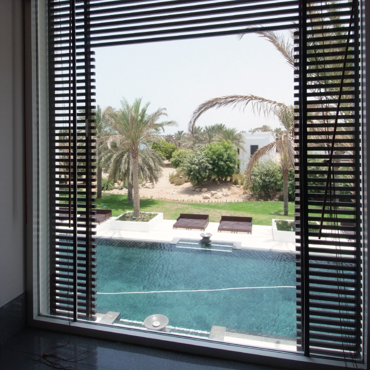 Image of window looking out towards a swimming pool. Part of Douglas OHI hopsitality & leisure services.